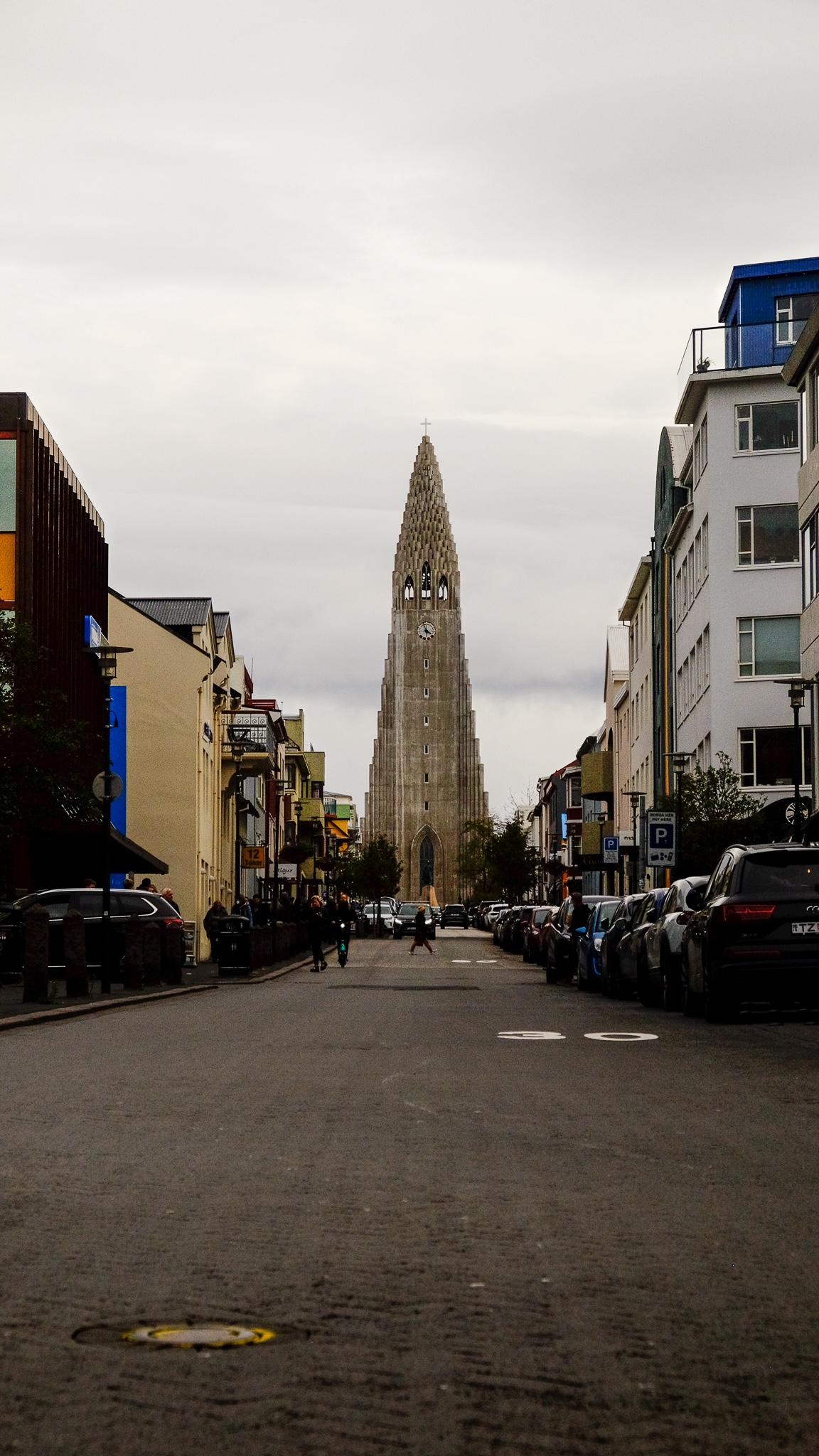 Hallgrimskirkja church up a road with an incline, imposing in the distance