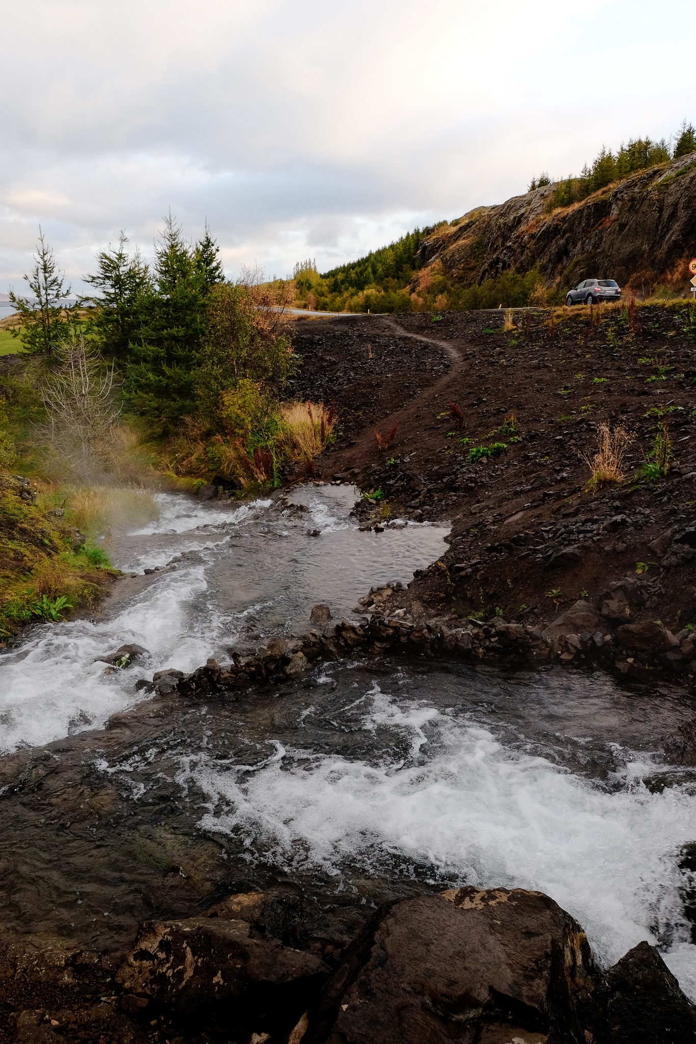 A naturally occuring geothermal stream flows where man made bath areas have been formed by creating small damns for anyone to bath in