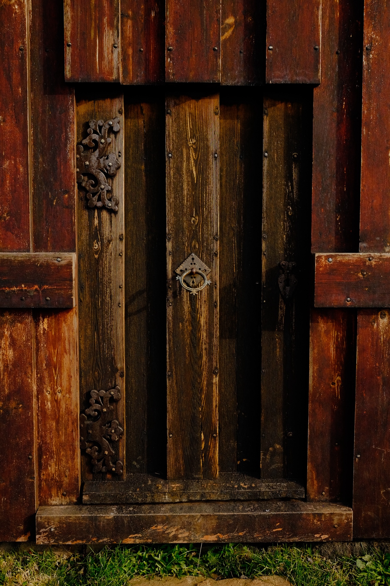 A thick, wooden, ornate door to the church