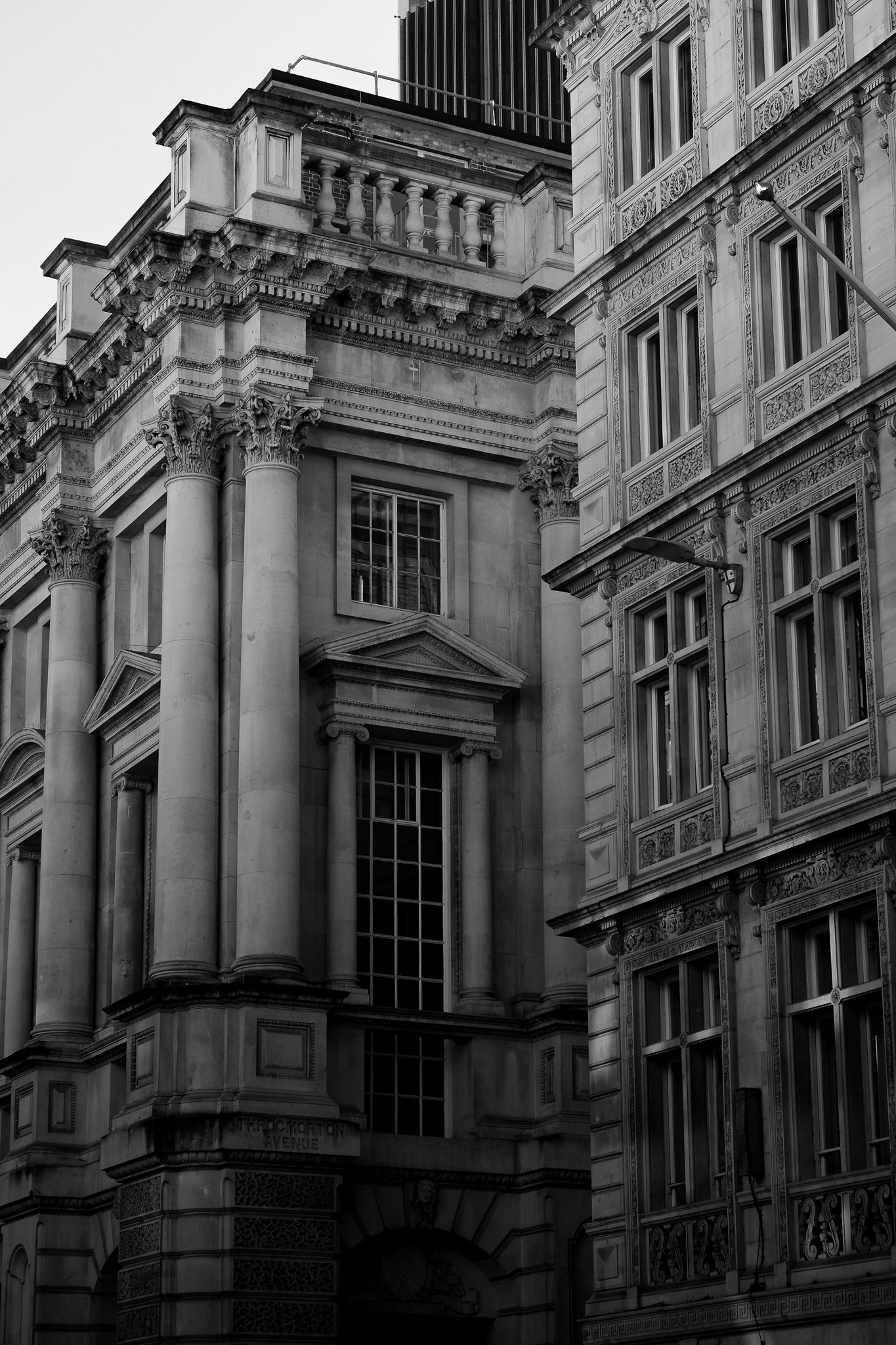 Black and white image of two ornate buildings on Throcmorton Avenue
