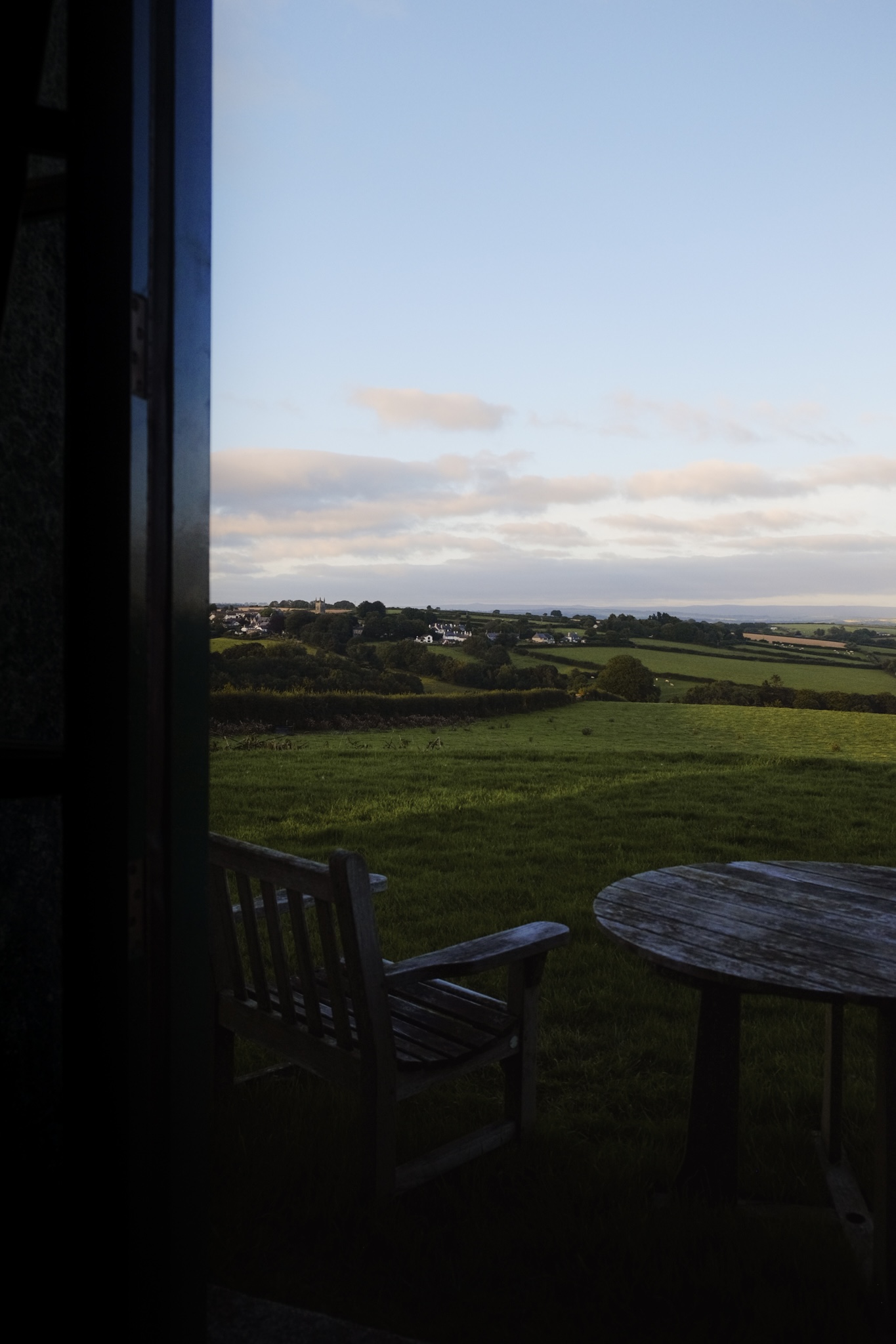 Cornwall farm land with a wooden table and chair