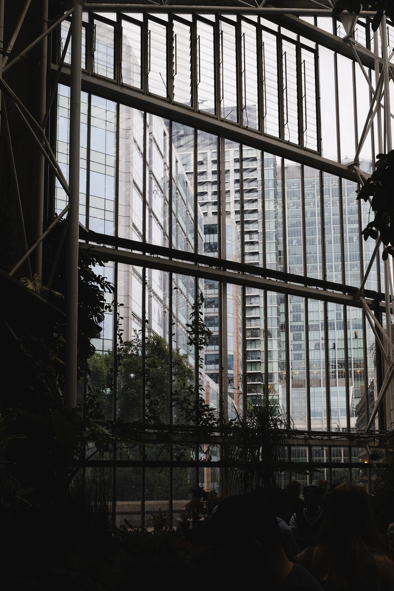 Through repeating vertical panes of glass you see London's corporate buildings draped in glass