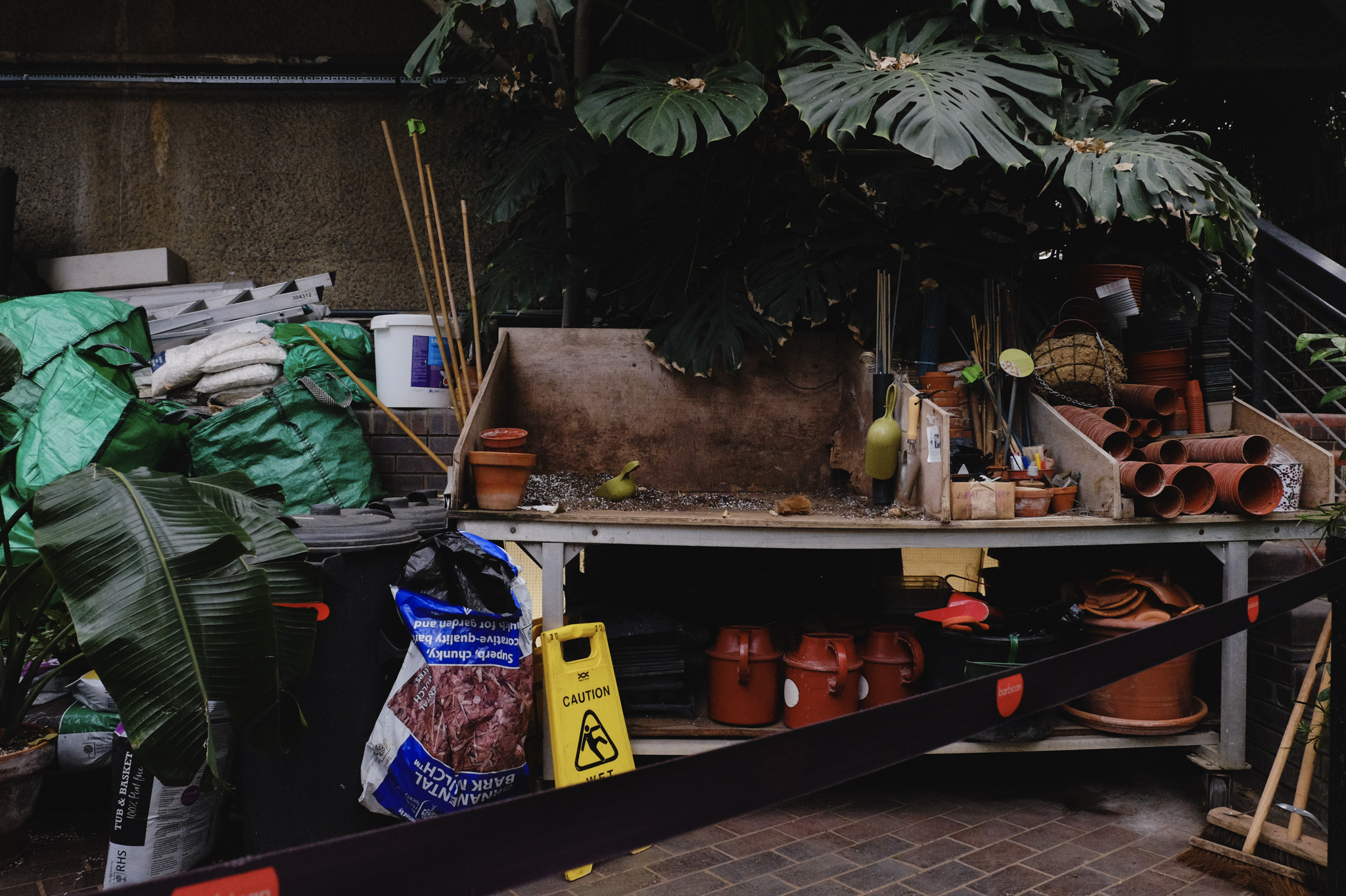 Fertilizer and gardening tools in a corner of the conservatory